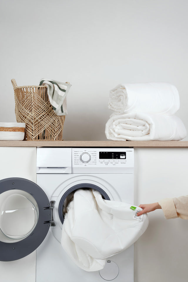 Folded towels beside a washing machine